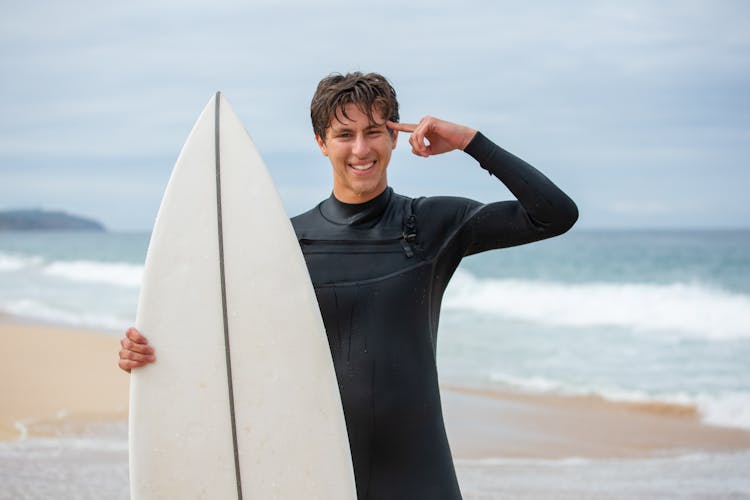 A Boy In A Black Wetsuit Posing