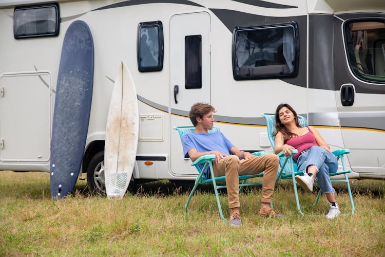 Photo Of A Couple Sitting On Blue Camping Chairs