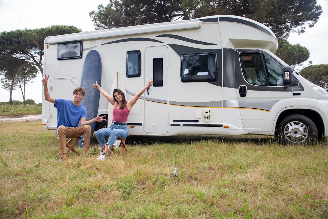 RV Camping Beginners Free Couple Sitting Outside the Rv Stock Photo