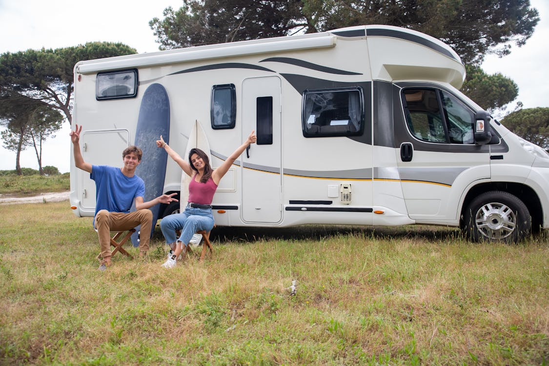 11 RV Beginner Tips Free Couple Sitting Outside the Rv Stock Photo