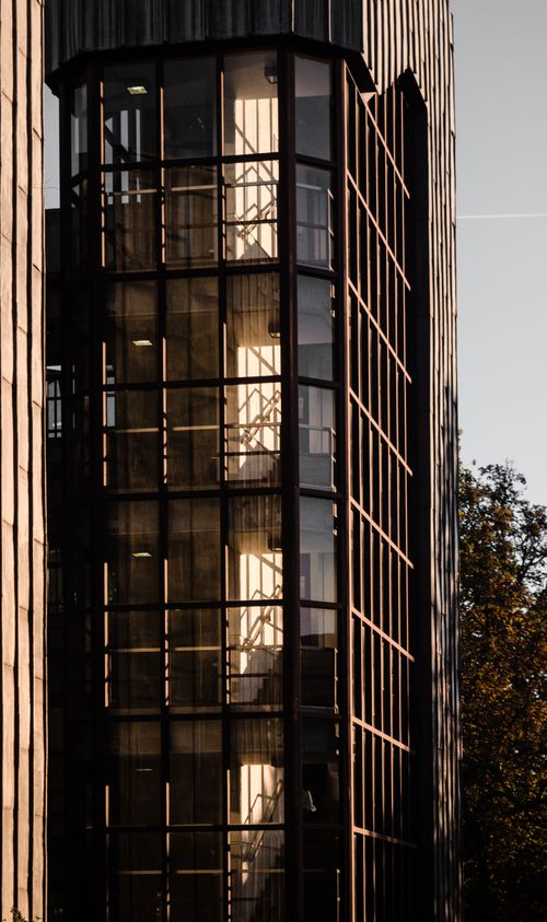 Free Vertical shot of a modern glass staircase in Wiesbaden, Germany, showcasing architectural symmetry and reflections. Stock Photo