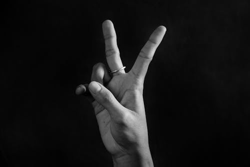 Free A Hand Doing the Peace Sign Stock Photo