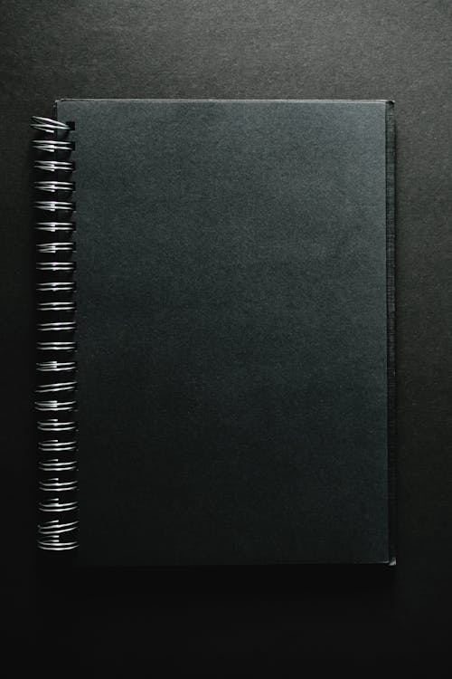 Free Notebook on Black Surface Stock Photo