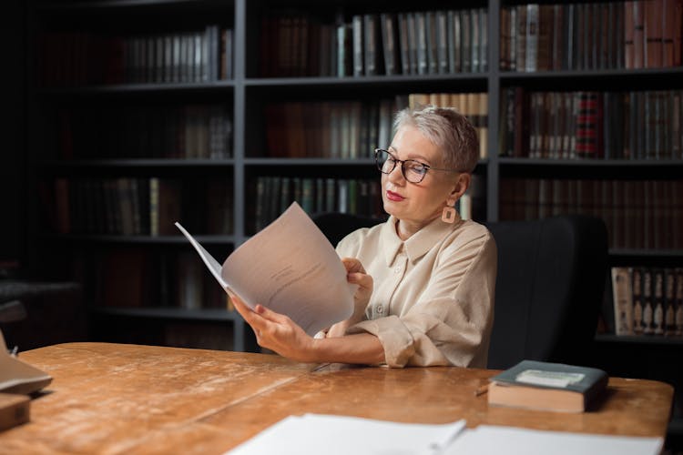 An Elderly Woman Reading A Manuscript