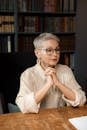 Professional Elderly Woman sitting beside a Table
