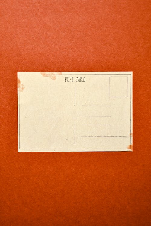 White Postcard on Red Surface 