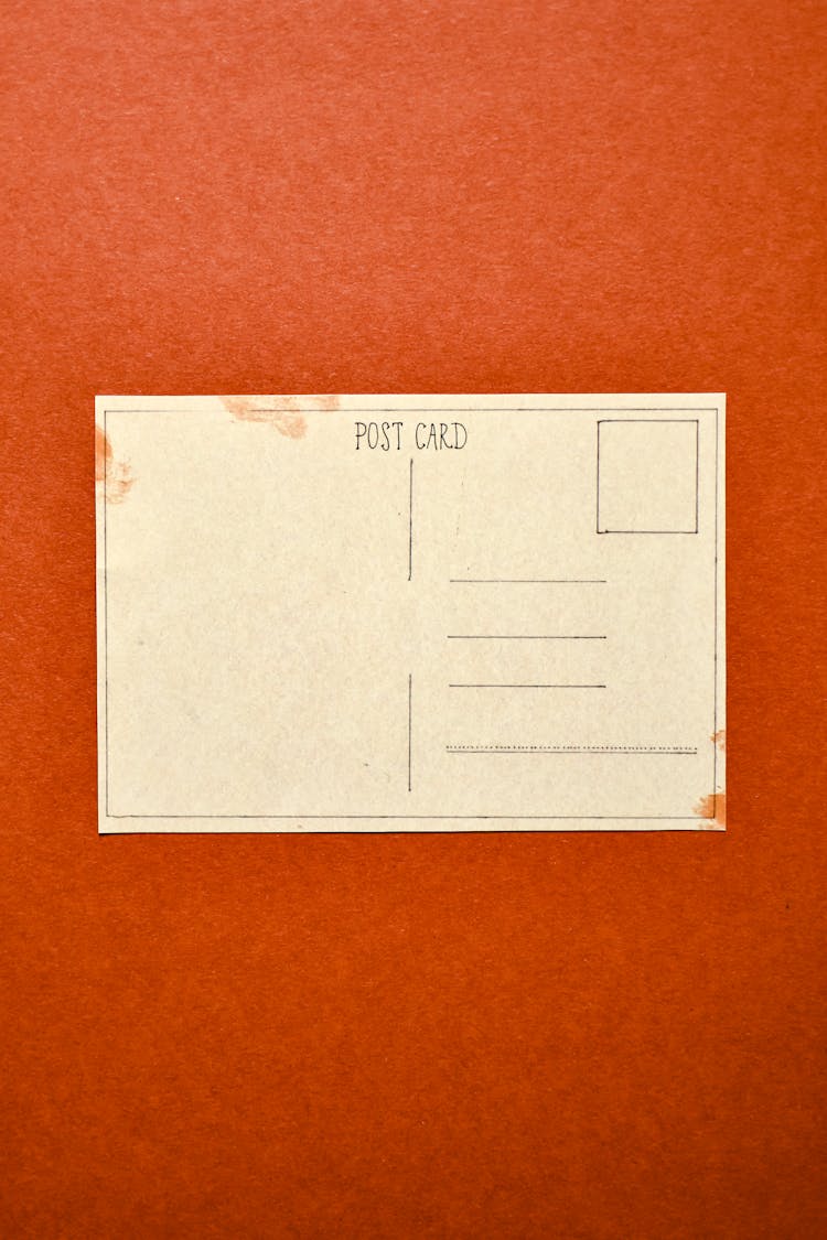 White Postcard On Red Surface 