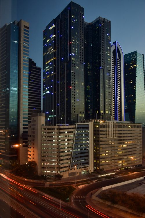 Free Long exposure photo of illuminated skyscrapers at twilight showcasing modern city architecture. Stock Photo