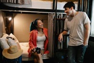 Cheerful diverse couple in hostel