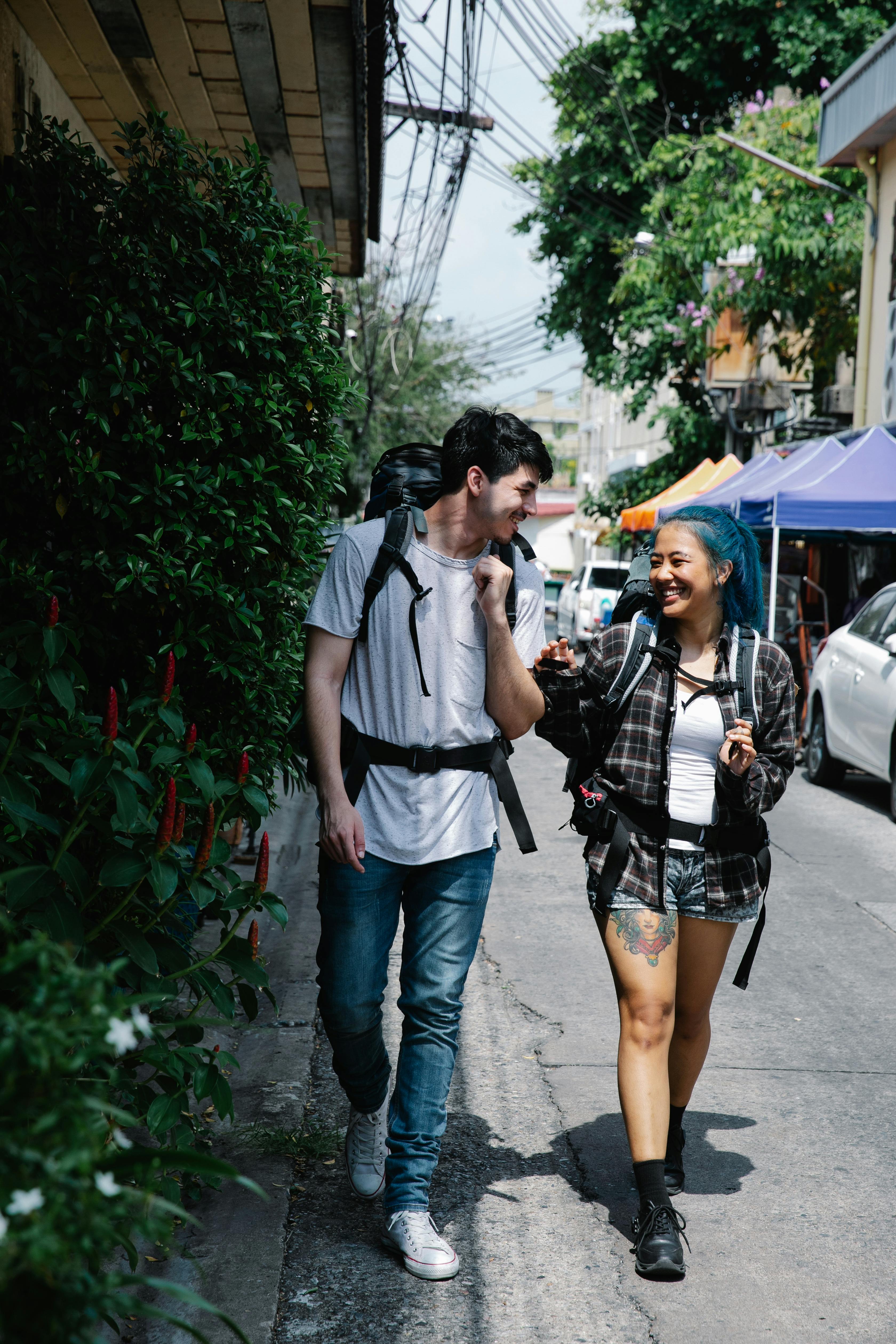 young multiracial couple tourists walking on street