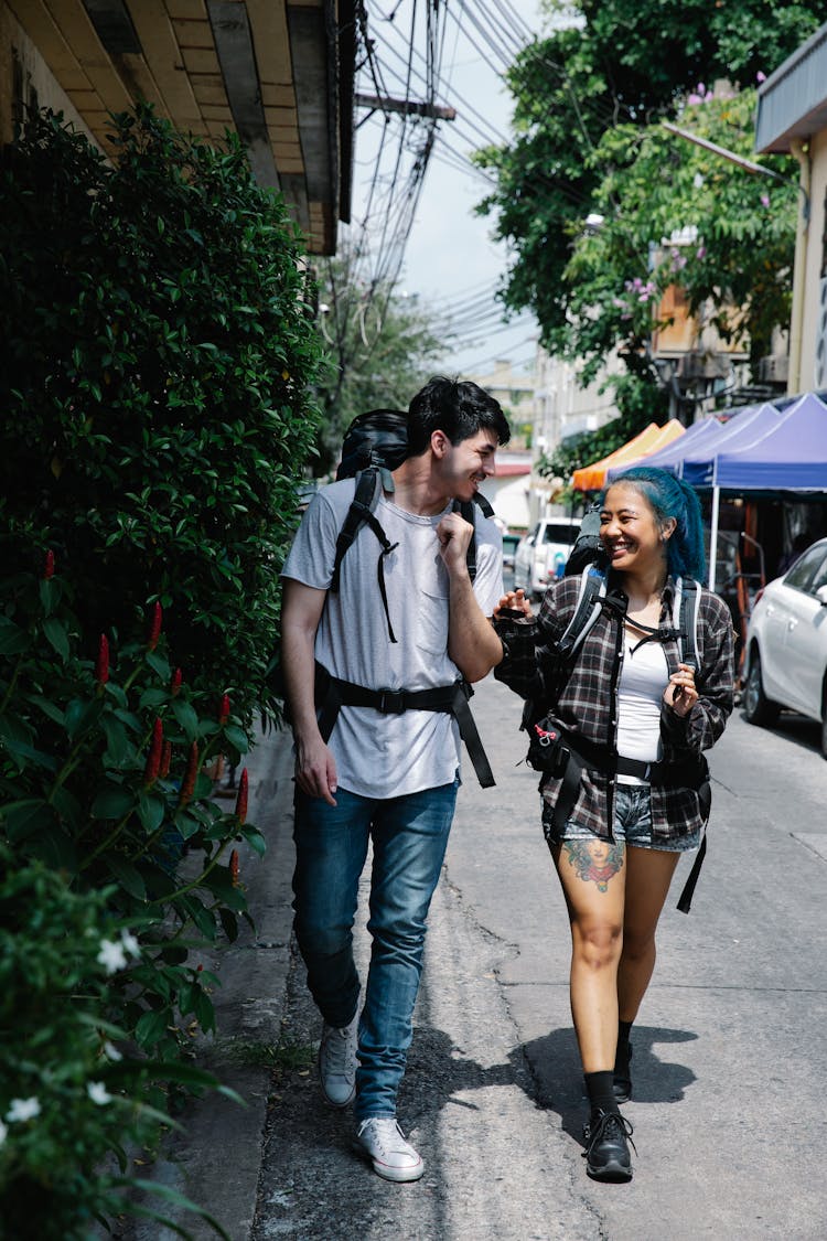 Young Multiracial Couple Tourists Walking On Street