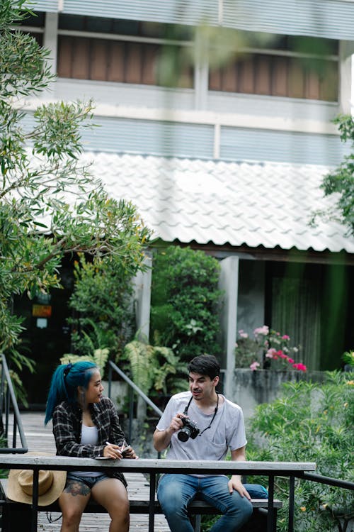 Cheerful couple talking while sitting on terrace