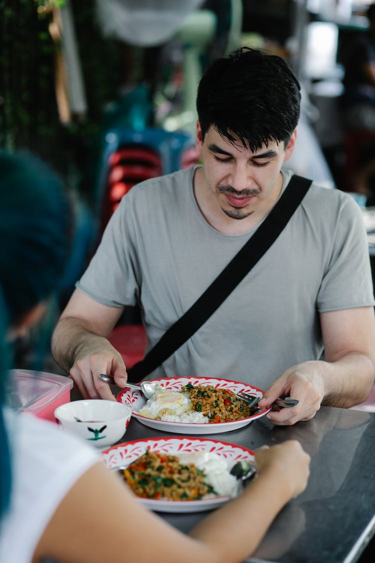 Man In Gray T-shirt Holding A Food Meal