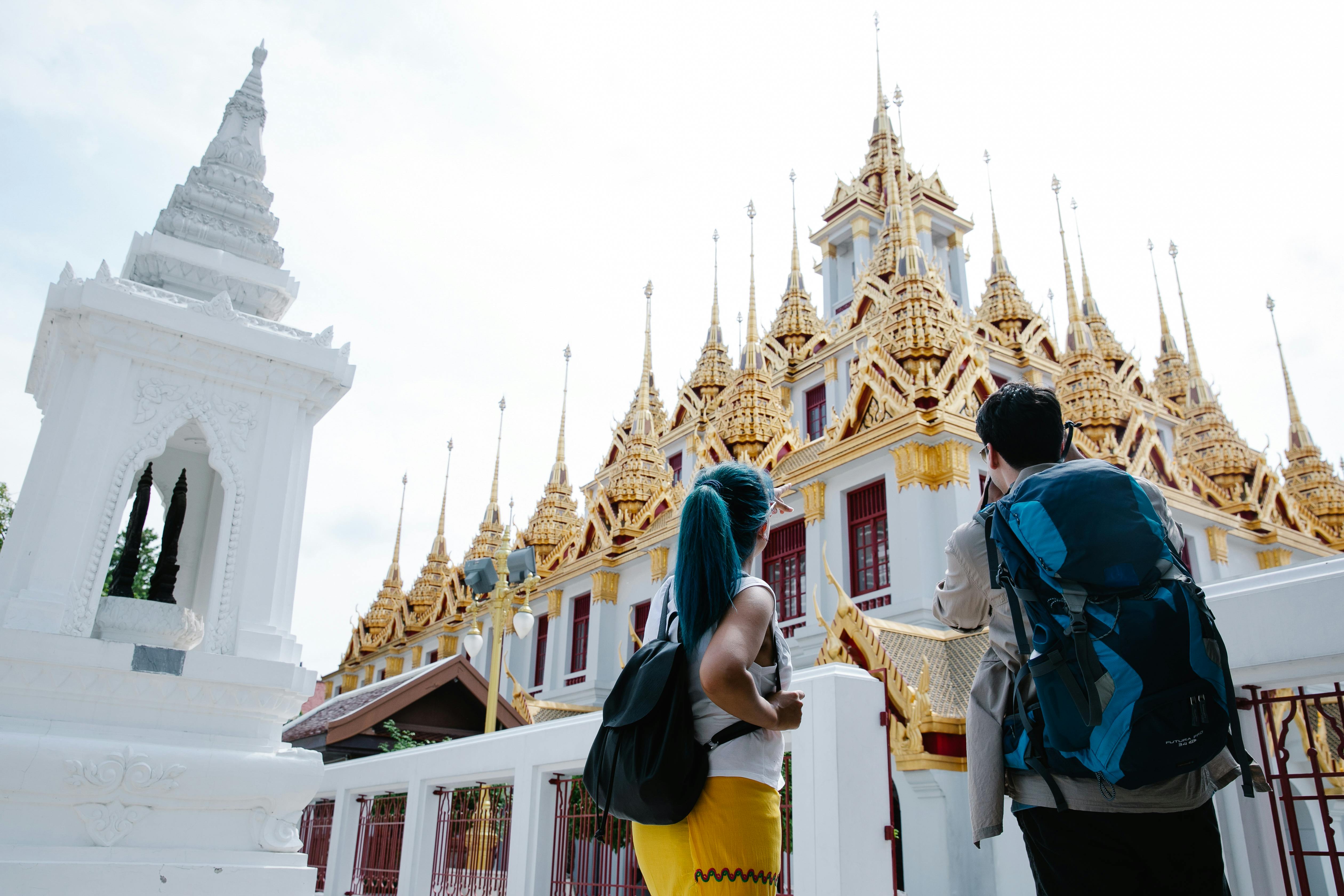 tourists looking at white and gold traditional architecture