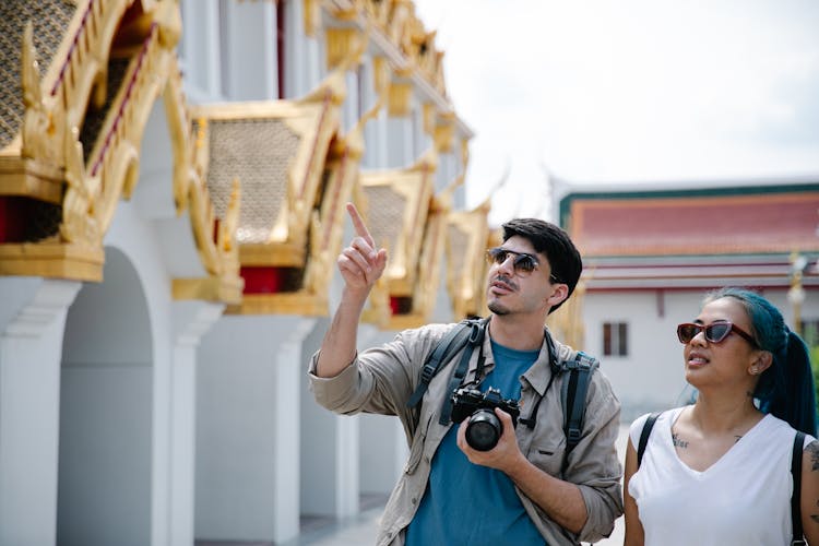 Photograph Of A Man With A Camera Pointing Up