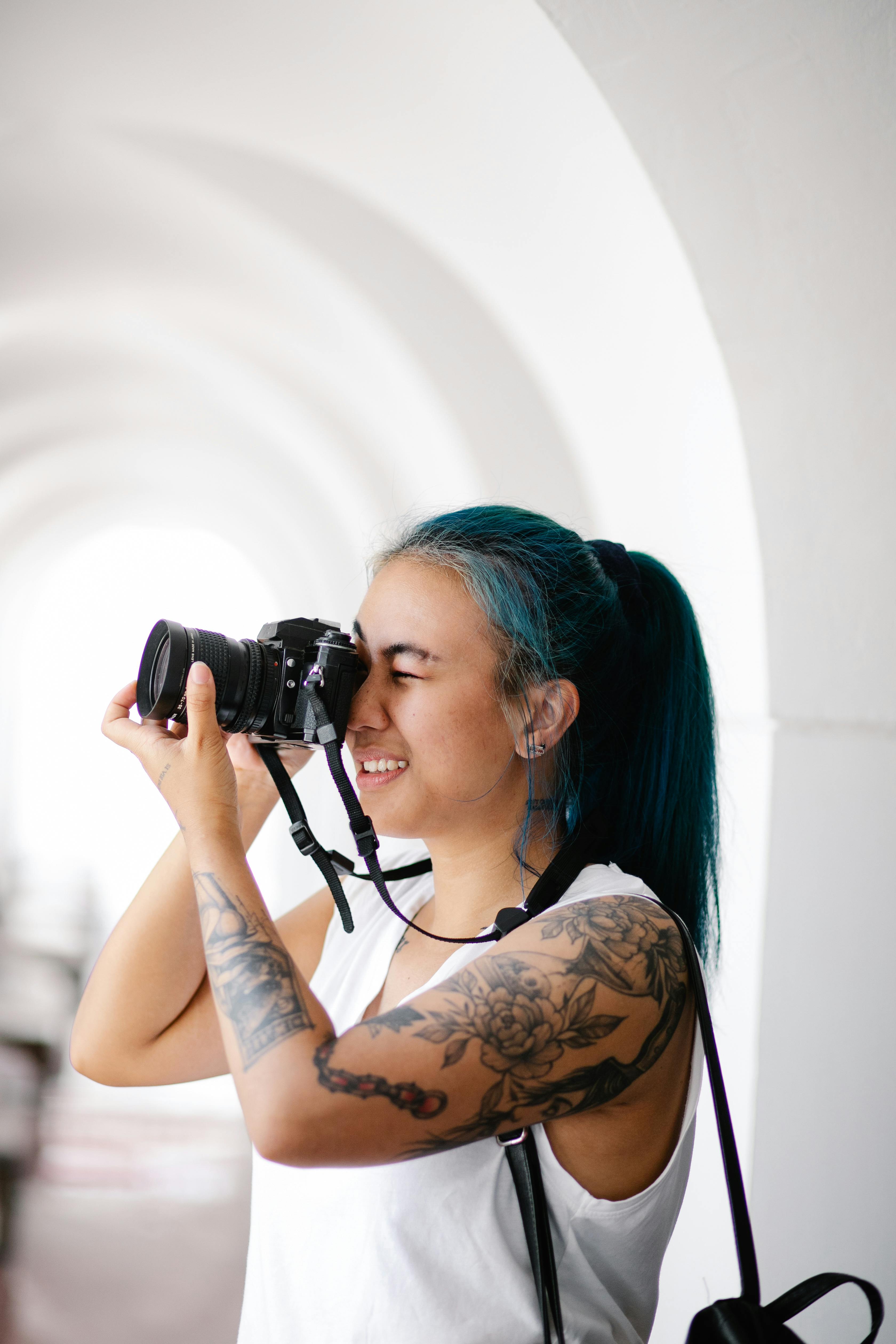 A woman with tattoos holding a camera Image & Design ID 0000527267 -  SmileTemplates.com