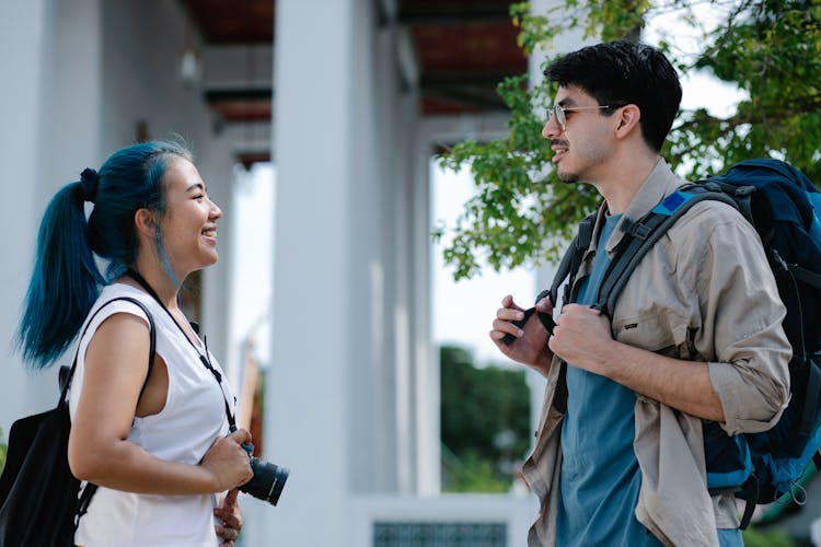 Man And Woman Standing Face To Face Smiling