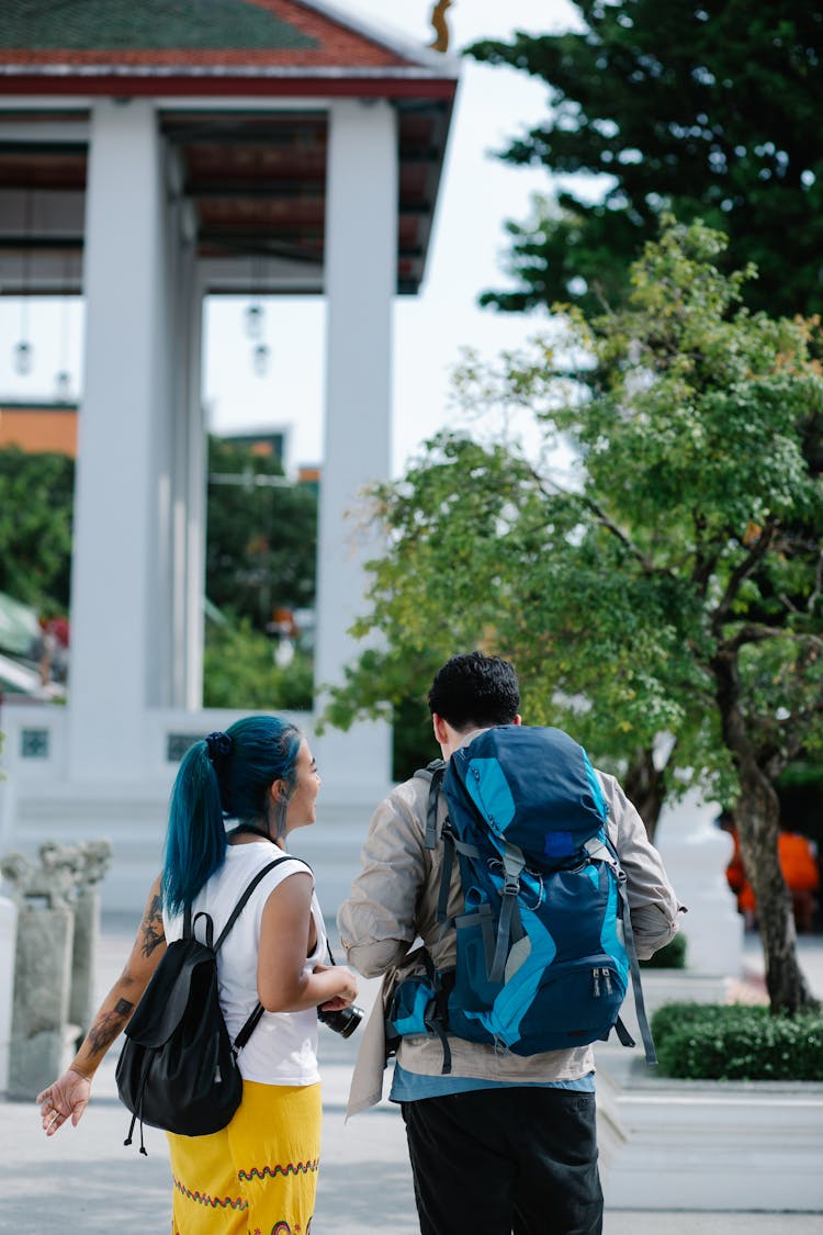 A Couple With Backpacks Touring The City