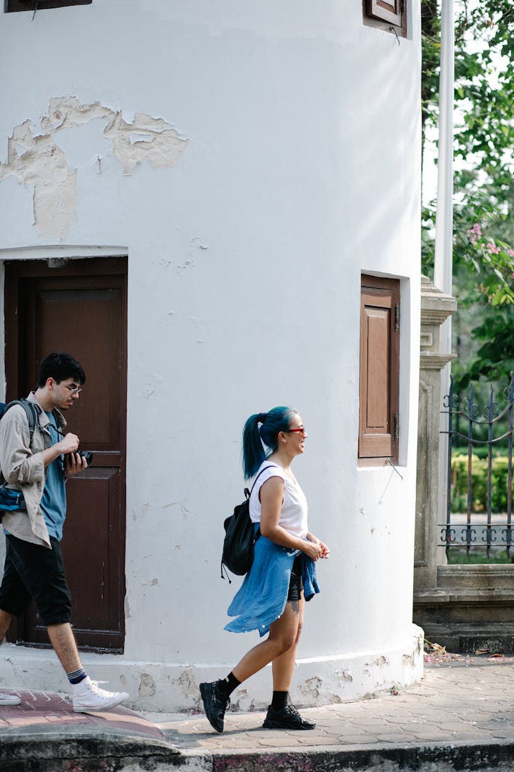 A Couple Touring The City By Walking