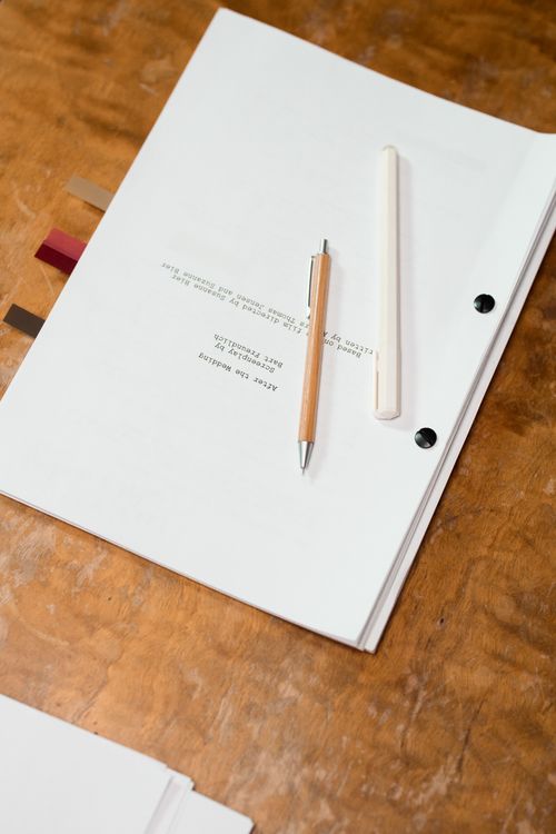 Pens over a Bind Manuscript · Free Stock Photo