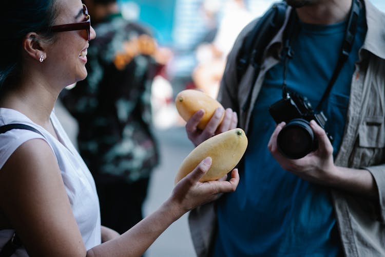 Woman Holding A Mango