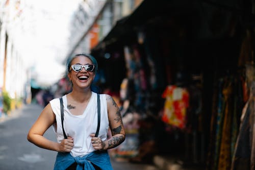 Free Woman in White Tank Top Wearing Black Sunglasses Stock Photo