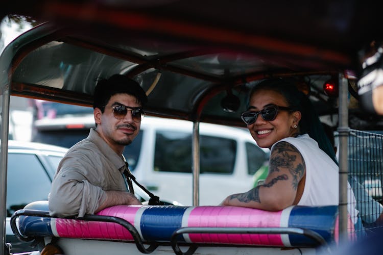 Man And Woman Riding An Auto Rickshaw