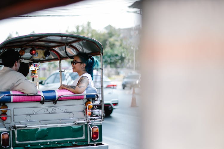 Woman And Man Riding An Auto Rickshaw