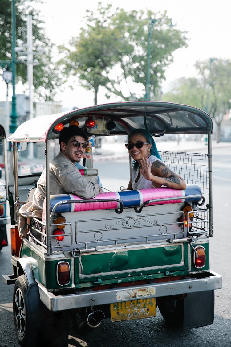 Man And Woman Riding An Auto Rickshaw