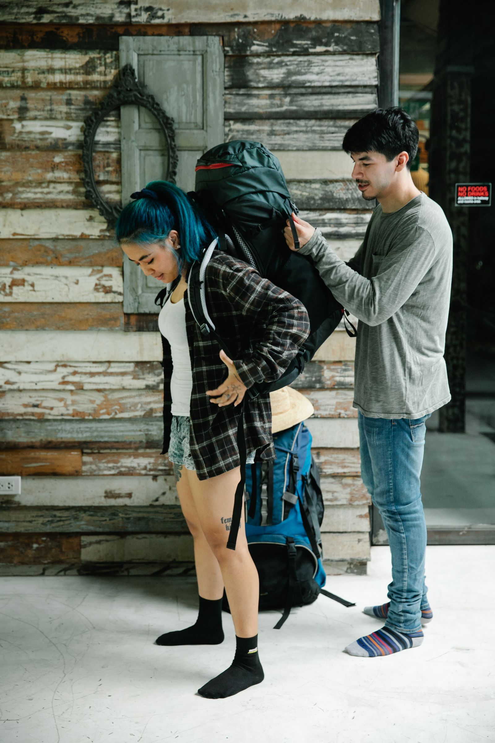 Backpacker packing clothes and gear into a travel backpack