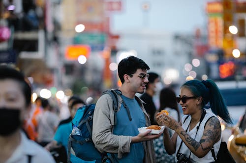 Two Tourists Eating Street Food