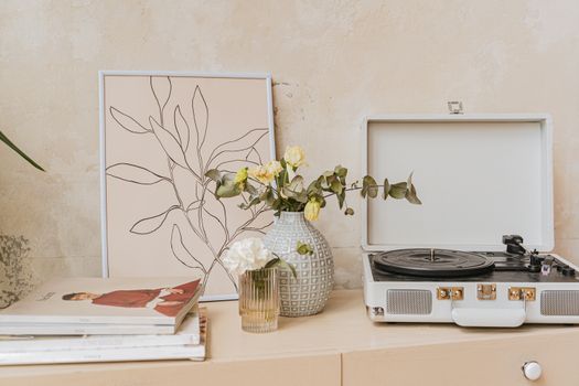 Yellow Flowers in Brown Woven Basket Beside White and Black Radio