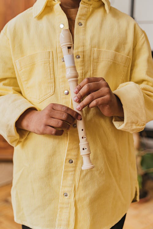 A Person Holding a Recorder 