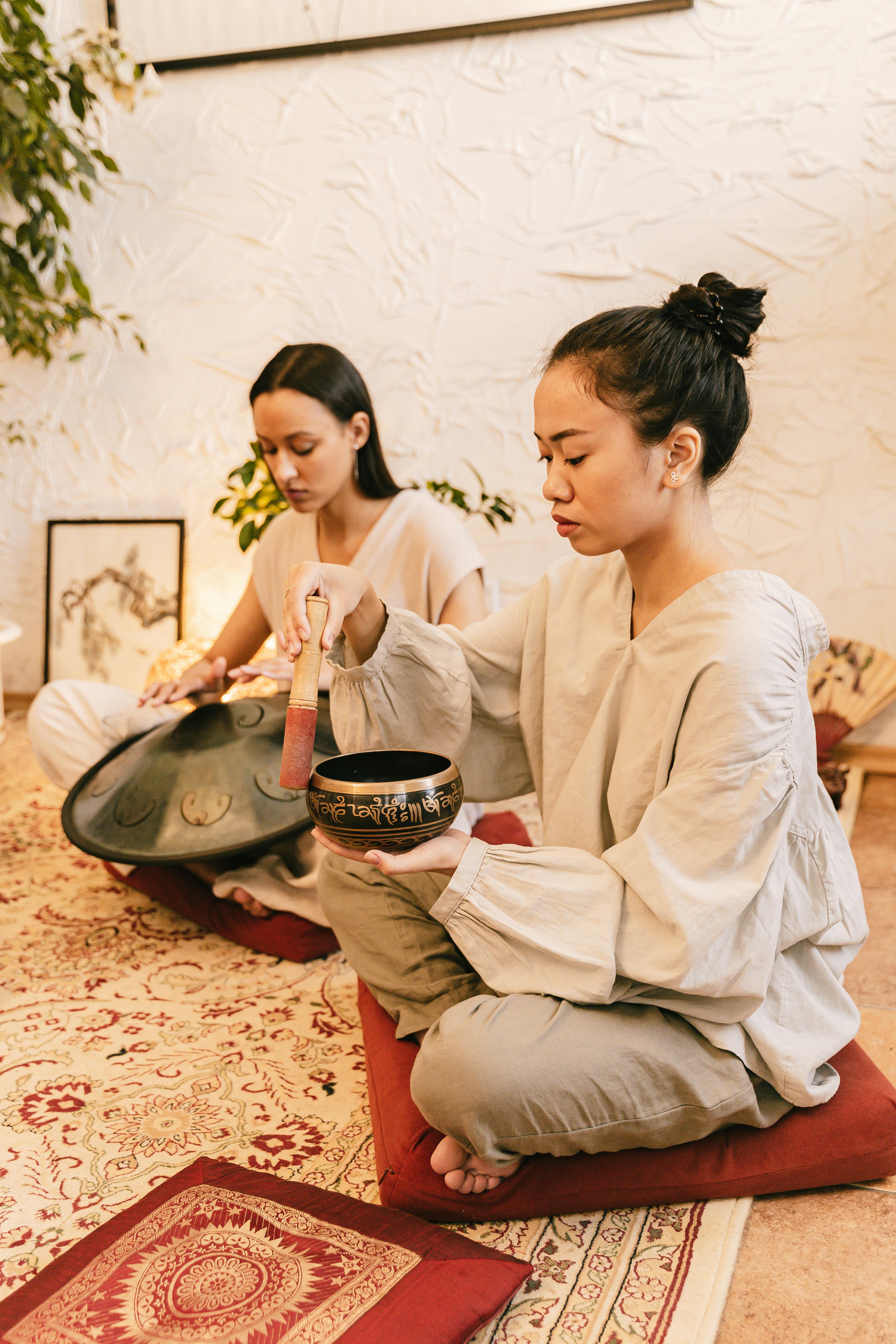 a woman using a singing bowl