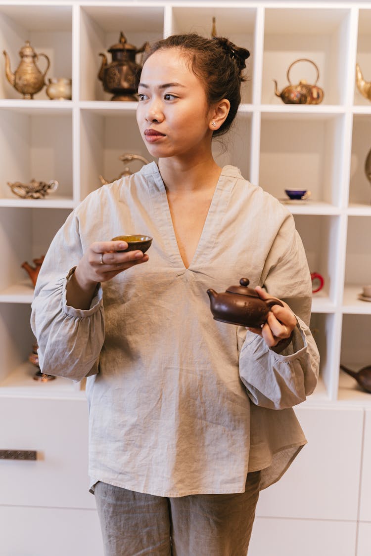 Woman Holding Teapot And Tea Cup