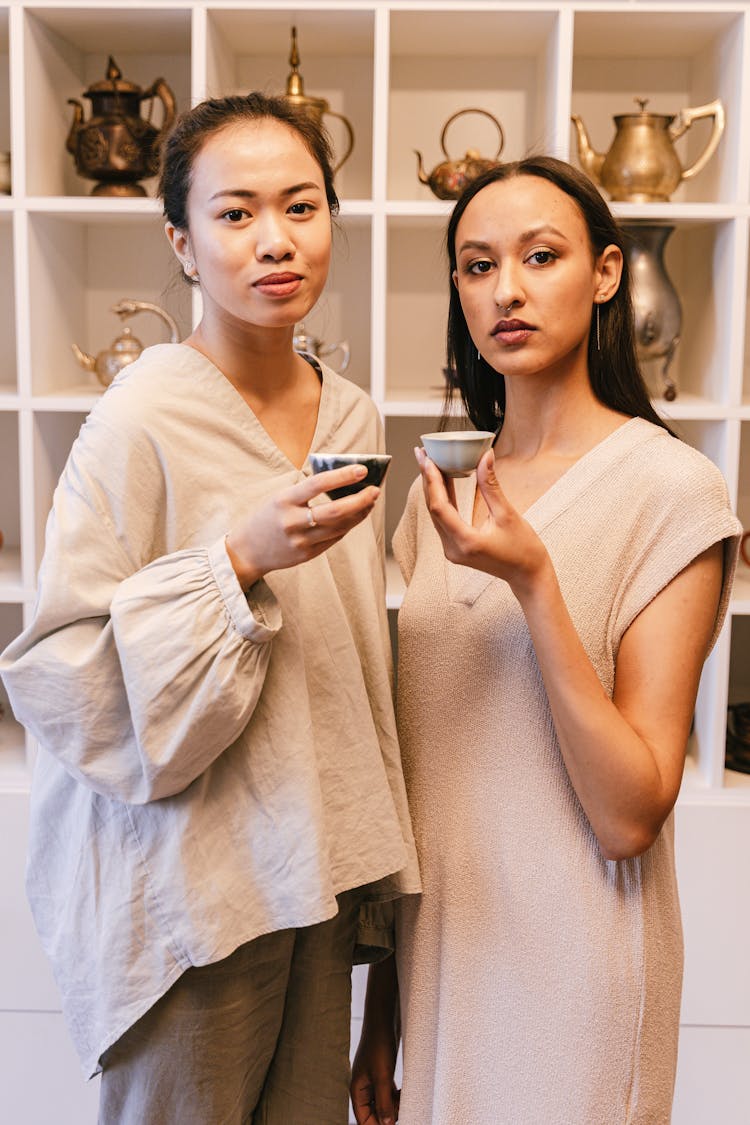 Women Holding Tea Cups