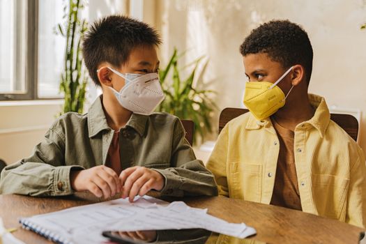 Two Boys Wearing Face Masks While Looking at Each Other