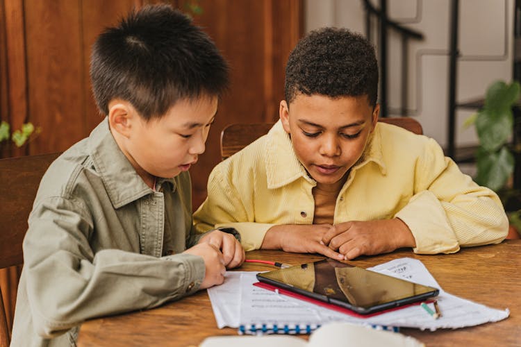 Boys Looking At The Screen Of A Tablet