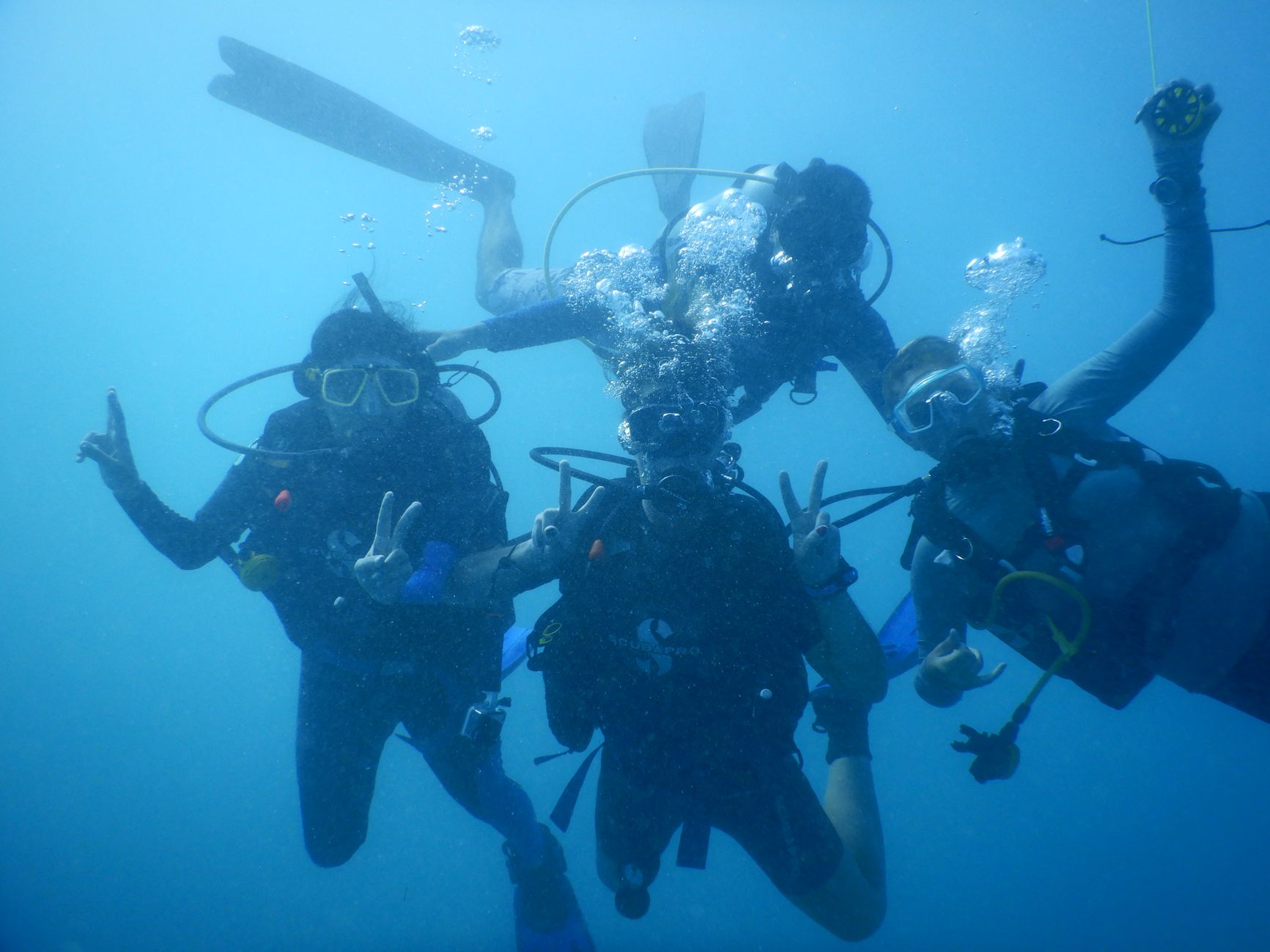 Divers enjoy an underwater adventure in Indonesia, showcasing scuba gear and marine exploration.