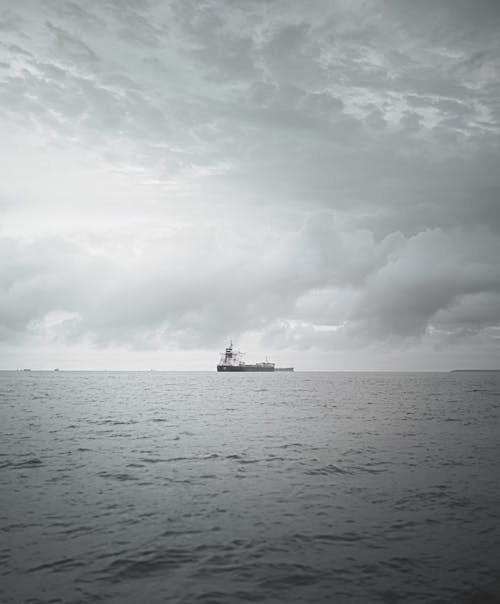 Grayscale Photograph of a Vessel on a Body of Water