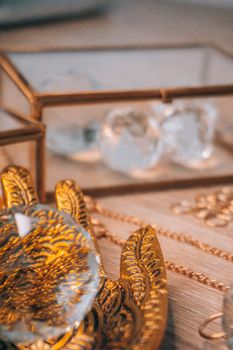 Beautiful arrangement of glass crystals and gold ornament on a tray, perfect for decor inspiration.