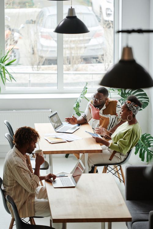 Free A group of professionals working and discussing ideas in a bright, contemporary office setting. Stock Photo