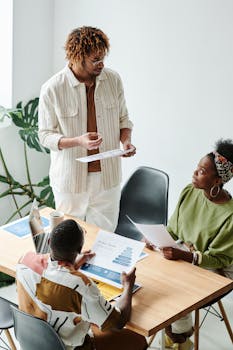 Team of diverse colleagues discussing marketing strategies in a bright, modern office.