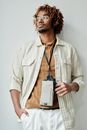 Man in White Button Up Shirt Holding White Leather Sling Bag
