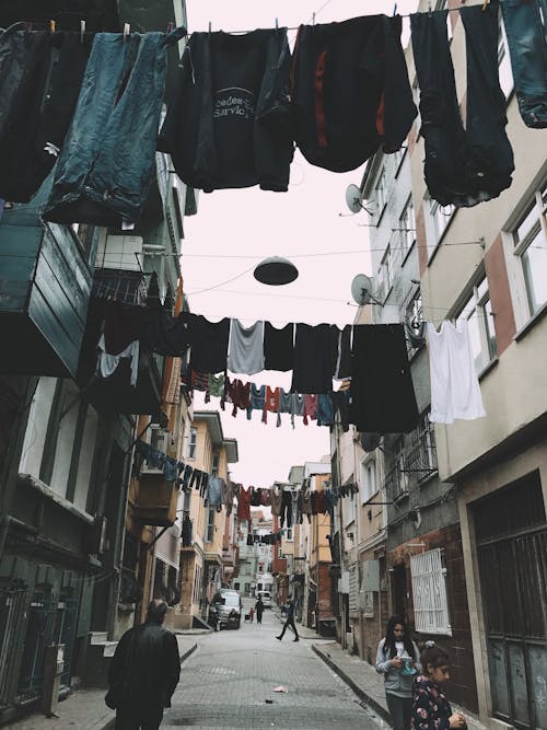 Clothes drying on clothesline between buildings