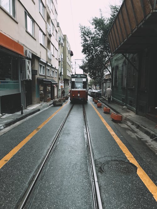 Tramway riding on rail in narrow street