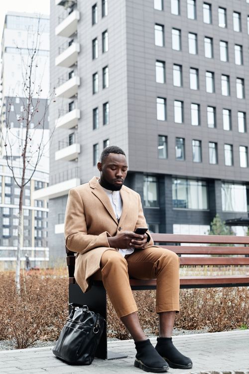Photo of a Man in a Brown Suit Sitting on the Bench · Free Stock Photo