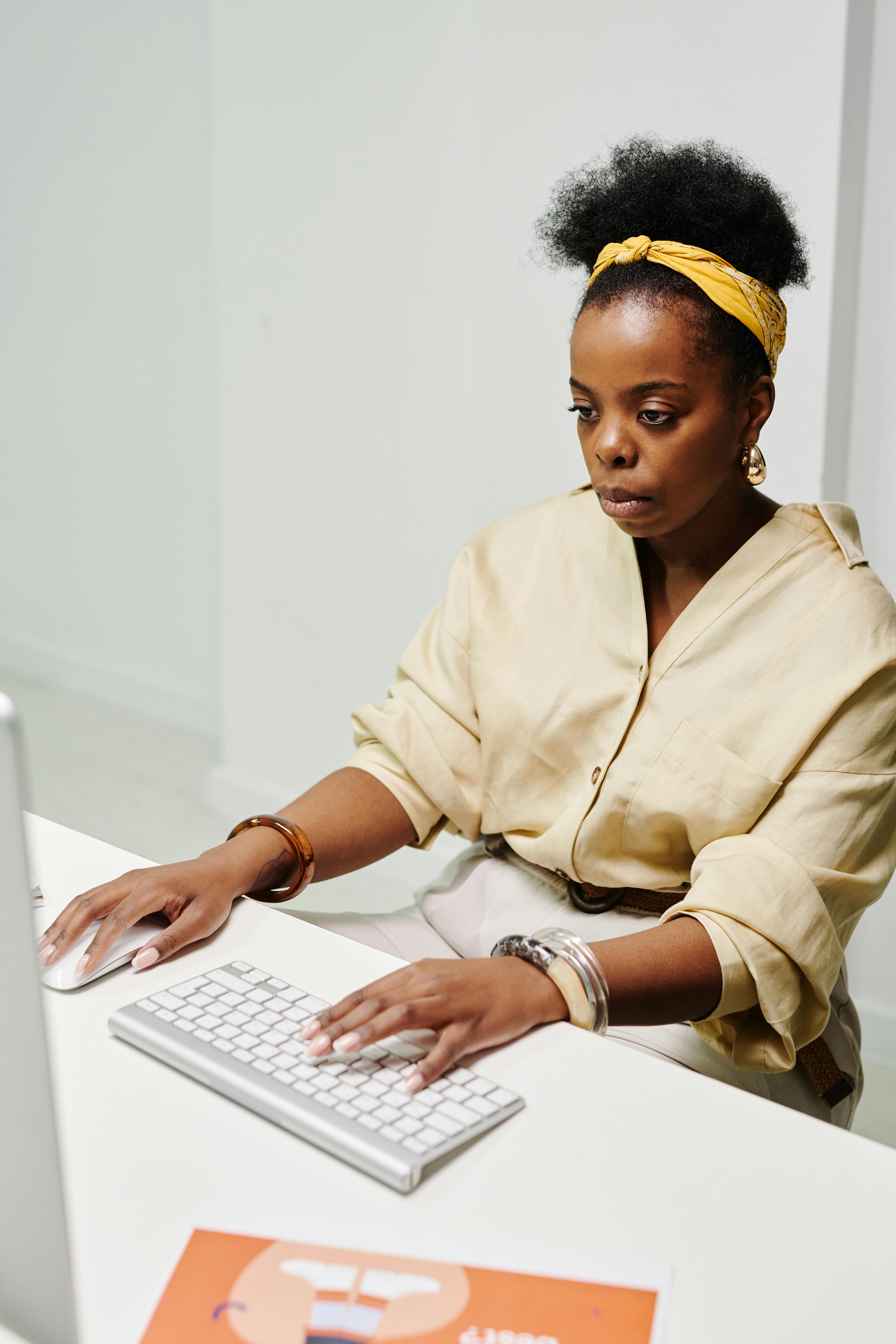 A woman intently working on her computer, embodying productivity and concentration.