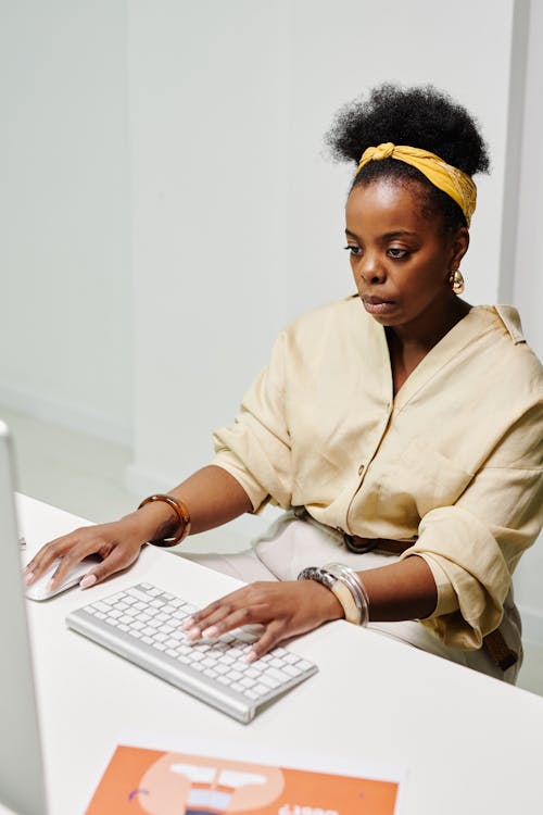 Free Photo of a Busy Woman Working on Her Computer Stock Photo