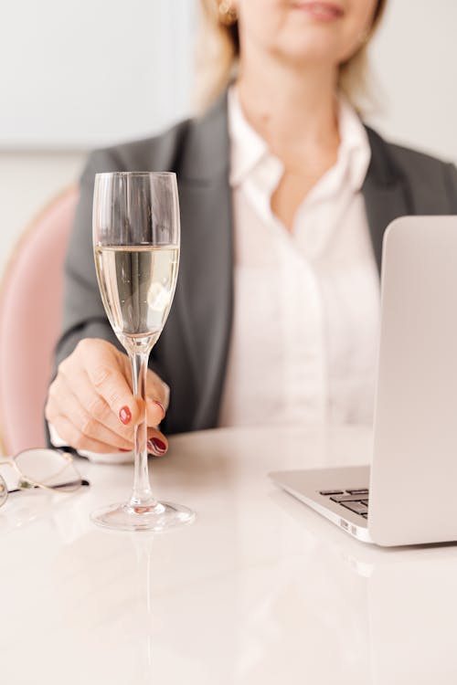Free Photo of a Woman's Hand Holding a Glass of Champagne Stock Photo